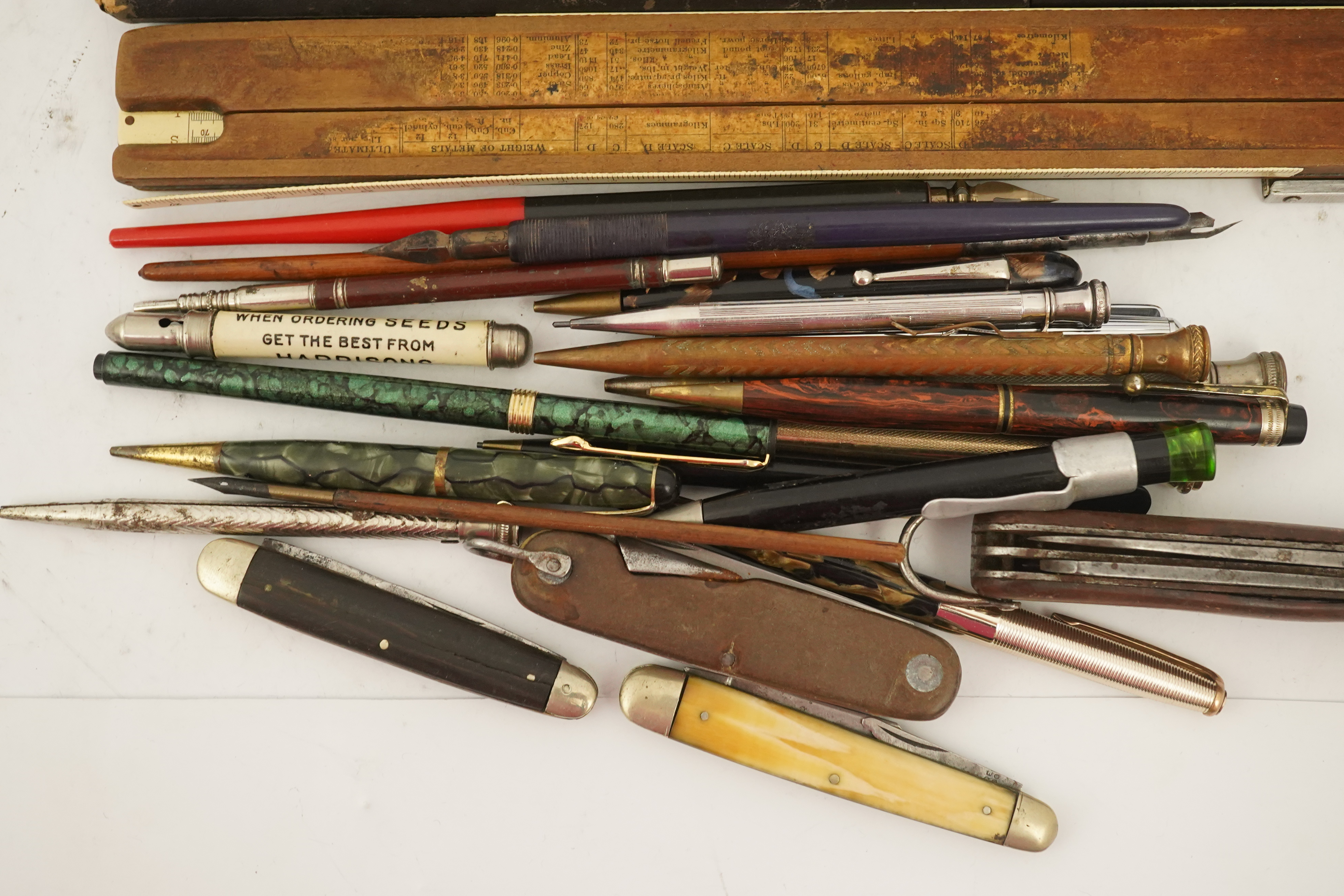 A collection of pens, etc. from 1950's and later and a collection of propelling pencils from 1930's and later, four penknives and a slide rule